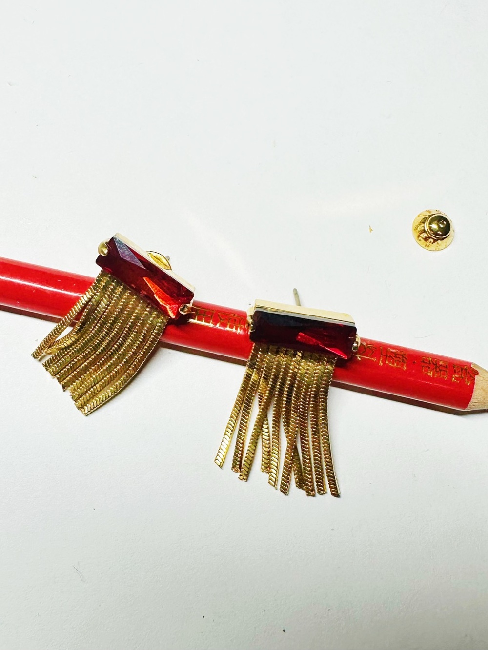 Henri Bendel Gold Fringe Earrings with Deep Red Crystal Bar